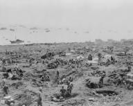 Marines in foxholes on the southeast edge of Motoyama Airfield #1, Iwo Jima. Landing craft are beached on right. February 23, 1945. World War 2. (BSLOC_2014_10_114)