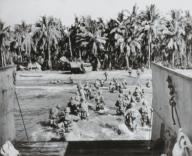 U.S. troops wade ashore, across heavily mined beaches, during invasion of Cebu Island. March 26, 1945. Philippines, World War 2. (BSLOC_2014_10_112)
