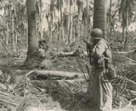 U.S. soldiers pinned down by a enemy machine gun, 50 feet from White Beach, Leyte Island. Oct. 21, 1944. Philippines, Battle of Leyte, World War 2. (BSLOC_2014_10_110)