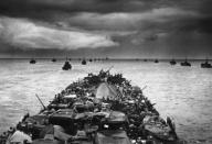 A LST (Landing Ship Tank) en route for the invasion of Cape Sansapor, New Guinea. It is followed by columns of troop-packed LCIs (Landing Craft Infantry) each capable of carrying 200 soldiers. July 30-31, 1944. GIs claimed that 