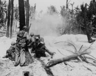 U.S. soldiers blasting some Japanese out of a pillbox on Kwajalein Atoll with a 37mm anti-tank gun. Jan. 31, 1944. Marshall Islands, World War 2. (BSLOC_2014_10_105)