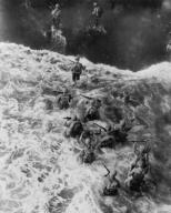 Overhead view of U.S. Marines taking the beach at Cape Gloucester, Papua New Guinea. Dec. 26, 1943. The invasion was part a Operation Cartwheel, aimed at neutralizing the major Japanese base at Rabaul, New Britain. World War 2. (BSLOC_2014_10_103)