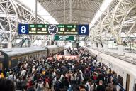 Crowd move on a platform at a railway station for high-speed trains in Nanjing in east China\'s Jiangsu province Tuesday, April 30, 2024. Chinese are going to have five days off in a national holiday