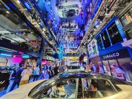 People tour in the booth of LYNK &amp; CO, a Chinese automaker, during the Beijing Auto