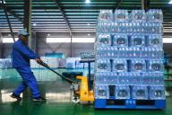 A man works at a plant of bottled water in Yuexi county in central China