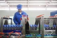 A man works on the bottling line at a plant of bottled water in Yuexi county in central China