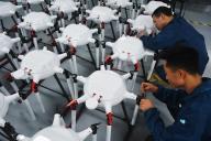 Workers assemble drones in a factory in Yuexi county in central China