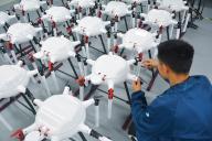 A worker assembles drones in a factory in Yuexi county in central China