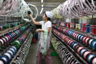A woman works in a silk factory in Fuyang city in central China