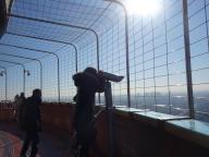 Tourists use the telescopes on the sightseeing platform of CCTV Tower in Beijing, China Monday, Jan. 15, 2024