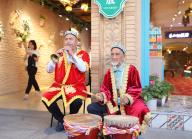 Two aged Uygur men play music for tourists to the Grand Bazaar in Urumqi in northwest China