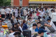 Students trade in a flea market as soon-to-be graduates sell off their books and other belongings on the campus of a university in Zhengzhou in central China\