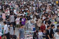 Students trade in a flea market as soon-to-be graduates sell off their books and other belongings on the campus of a university in Zhengzhou in central China\