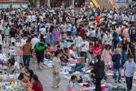 Students trade in a flea market as soon-to-be graduates sell off their books and other belongings on the campus of a university in Zhengzhou in central China\'s Henan province Sunday, June 02, 2024