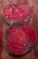 Two beet halves on wood background