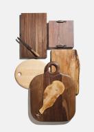 High angle view of an assortment of wood cutting boards on white background