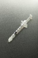Botox syringe on dark gray background
