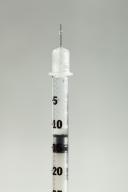 Botox syringe on light gray background