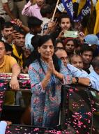 NEW DELHI, INDIA - MAY 5: Sunita Kejriwal, wife of Delhi CM Arvind Kejriwal, greets the crowd during the roadshow for the upcoming Lok Sabha Elections, at village Deoli near Sangam Vihar, on May 5, 2024 in New Delhi, India. Sunita Kejriwal alleged Arvind Kejriwal was put in jail before the elections to "stifle" his voice and urged people to vote against "dictatorship" when the national capital goes to polls on May 25. Sunita held her third roadshow in the national capital in south Delhi in support of AAP candidate Sahiram Pahalwan on Sunday. (Photo by Vipin Kumar\/Hindustan Times