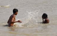 NEW DELHI, INDIA - MAY 5: Children playing with water to beat the heat at a pond near Geeta Colony, on May 5, 2024 in New Delhi, India. As temperature is rise in Delhi NCR. (Photo by Sanjeev Verma\/Hindustan Times