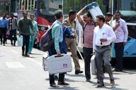 NAVI MUMBAI, INDIA - MAY 18: Election officials carry a (EVM) ballot box for distribution for constituency election scheduled on 20th May 2024 at Agri Koli Bhavan Nerul,, on May 18, 2024 in Navi Mumbai, India. (Photo by Bachchan Kumar\/Hindustan Times