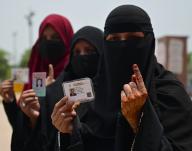 LUCKNOW, INDIA - MAY 20: Burqa-clad voters show their inked fingers after casting their at Hussainabad polling station during the fifth phase of Lok Sabha Election on May 20, 2024 in Lucknow, India. According to the Election Commission of India, 57.57 per cent turnout was recorded in 49 seats in the fifth phase of polling on May 20. (Photo by Mushtaq Ali/Hindustan Times