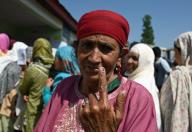 BANDIPORA, INDIA - MAY 20: A woman shows her marked finger after casting her vote outside a polling station during the fifth phase of the Lok Sabha elections in Sumbal area of Bandipora district, north of Srinagar,on 20 May 2024.(Photo By Waseem Andrabi/Hindustan Times