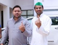 PATNA, INDIA - JUNE 1: RJD leader Tejashwi Yadav with Tej Pratap Yadav showing finger ink mark after cast vote during seventh and last phase of Lok Sabha election at Bihar Veterinary College on June 1, 2024 in Patna, India. (Photo by Santosh Kumar\/Hindustan Times