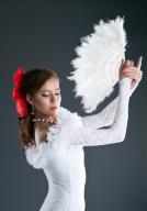 Woman posing in flamenco white costume with