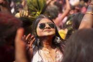 A girl dancing in the beat of music as she celebrate Holi on a street, the Hindu spring festival of colours on March 25, 2024 in Guwahati, Assam, India. Holi, also known as the Festival of Colors or the Festival of Spring, is one of the most vibrant 