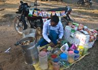 Man, selling snacks, motorcycle, rural market, West Bengal, India