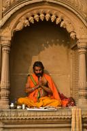Hindu, man, worshipping the sun, Varanasi, India. monument