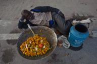 Man, lying on the ground, street vendor, street food, Allahabad, India