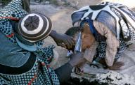 Funerary ritual, Hair cutting, woman, Lesotho. Funerary ritual : hair cutting after the burial of a
