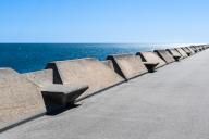 Concrete benches on the Moll de Llevant waterfront promenade, a 4.5 km long promenade for joggers, walkers, cyclists and skaters at the harbour of Tarragona, Spain