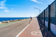 Moll de Llevant waterfront promenade, a 4.5 km long promenade for joggers, walkers, cyclists and skaters at the harbour of Tarragona, Spain