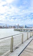 Waterfront promenade, Williamsburg, with view of Manhattan Bridge and across the East River to the Manhattan skyline, New York City, USA, North