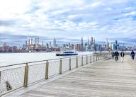 Domino Park waterfront promenade, Williamsburg, with a view across the East River to the Manhattan skyline, New York City, USA, North