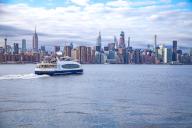Ferryboat of the New York City Ferry Service on the East River against the backdrop of Manhattan, New York City, USA, North