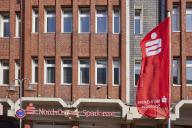 Nord-Ostsee Sparkasse with facade and flag in Husum, district of Nordfriesland, Schleswig-Holstein, Germany