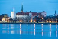 Riga Castle, seat of the Latvian President, in front of the Daugava River at blue hour, Riga, Latvia