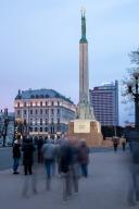 Freedom Monument, Mila holding three golden stars, behind it Radisson Hotel, Riga, Latvia