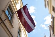 The flag of Latvia flies in the historic centre of Riga, Latvia