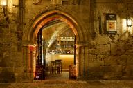 Illuminated entrance of a restaurant with warm light and vaulted architecture at night, night shot, Rhodes Old Town, Rhodes, Dodecanese, Greek Islands, Greece