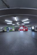 Empty underground railway hall with circular ceiling lighting and clear lines, Berlin, Germany
