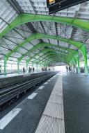S-Bahn station with striking green roof and empty tracks on a bright day, Berlin, Germany