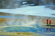 People standing in a winter landscape in front of a steaming mud spring, Namafjall, Myvatn, Iceland