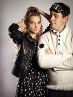 Young funny couple in retro style clothes over light