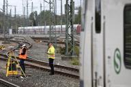 Railway worker surveying on the tracks with S-Bahn, Hanover-Nordstadt station, Hanover, Lower Saxony, Germany