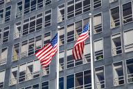Two US flags on a glass façade in the financial district, Manhattan, New York